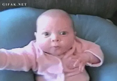 a baby bringing its hand towards it's face with a look of realization on its face