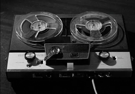 an old recording device with the tape wheels spinning